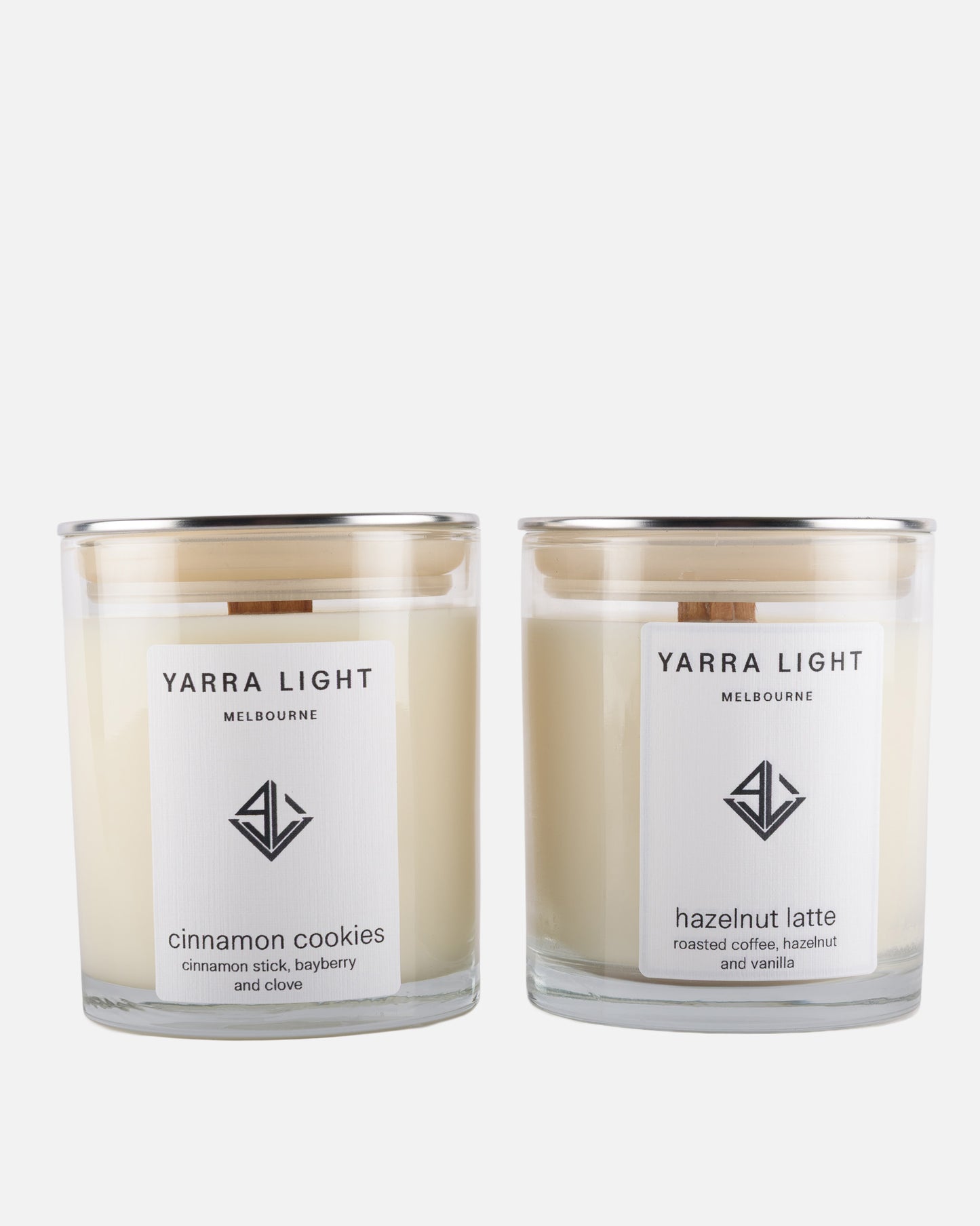 Two Yarra Light soy wax candles, one labeled 'cinnamon cookies' and the other 'hazelnut latte', on a white background.