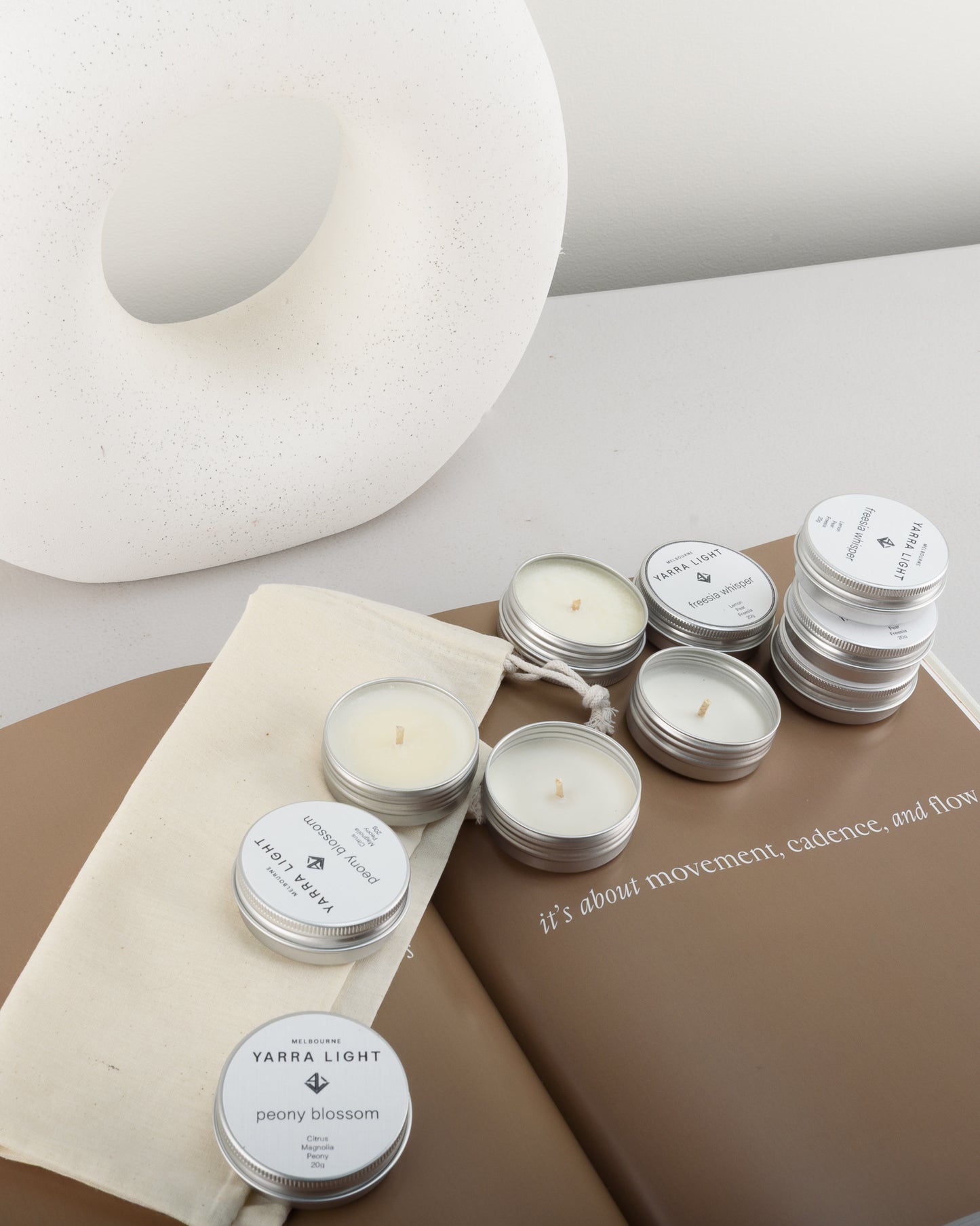 Discovery candle kit featuring ten soy wax scented sample candle tins neatly arranged in a reusable bag, ideal for trying a variety of fragrances or gifting.