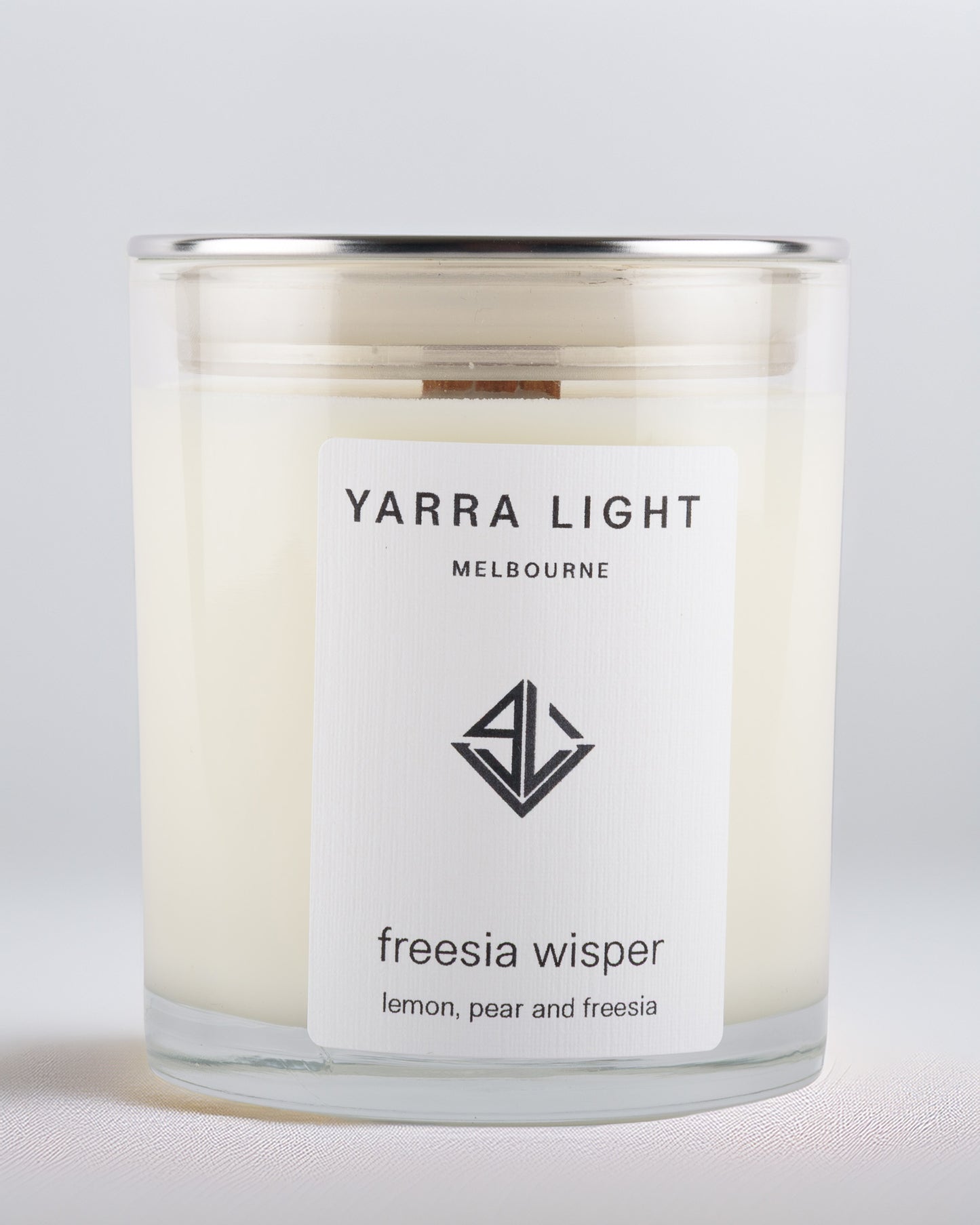 Yarra Light Melbourne soy wax candle with freesia fragrance on a light gray background