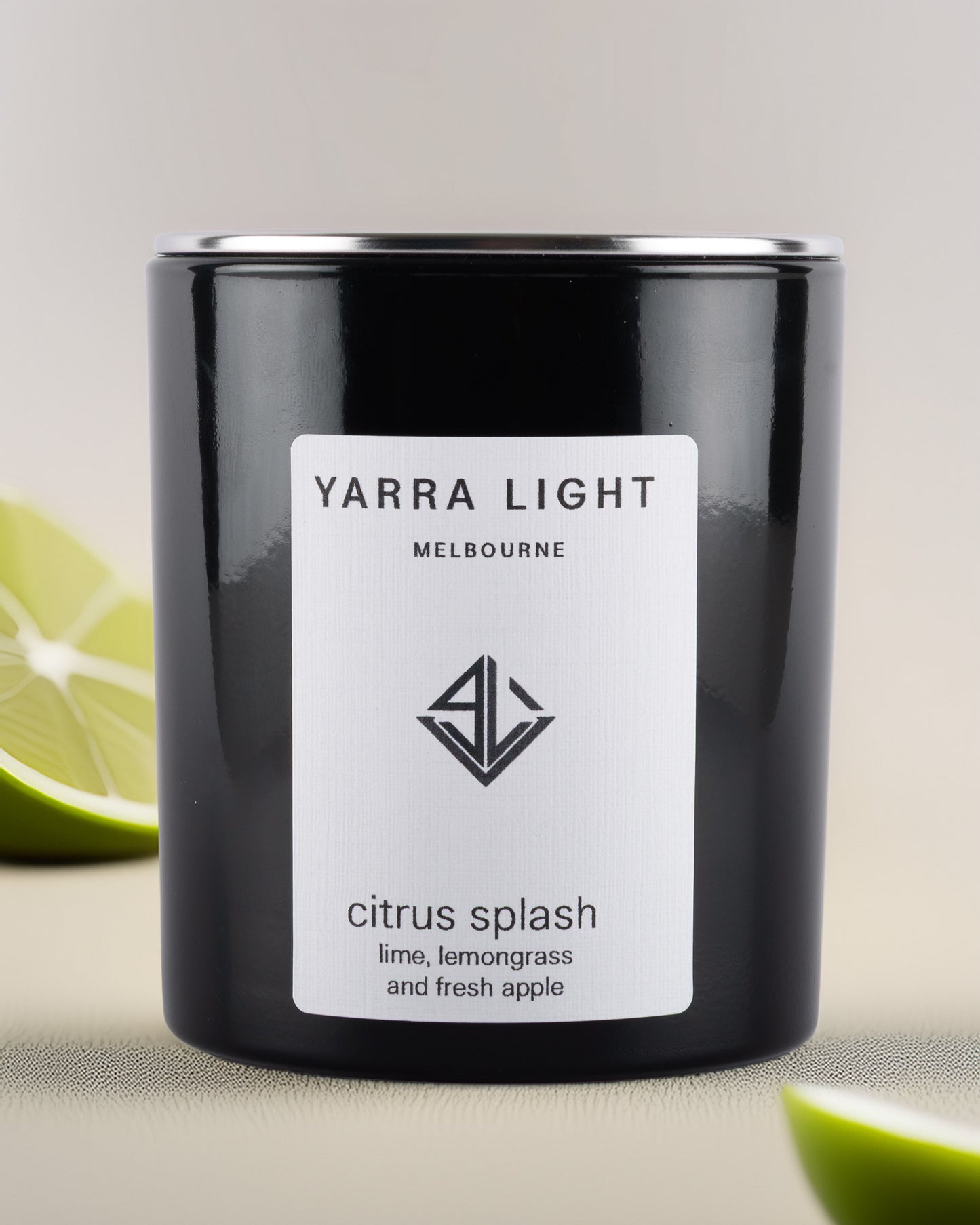 Yarra Light citrus splash soy wax candle and lime slices in the background