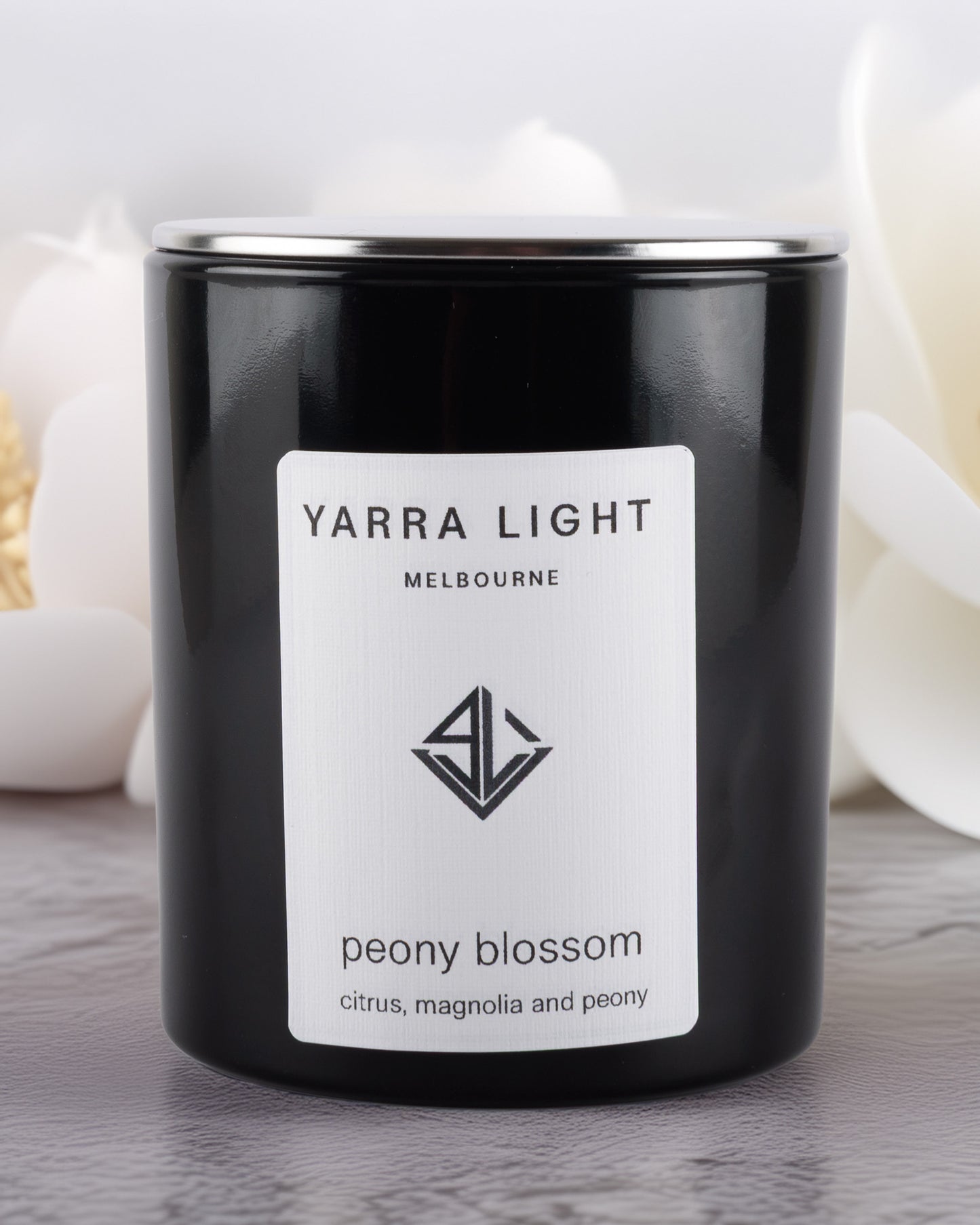 Yarra Light peony blossom soy wax candle on a wooden surface