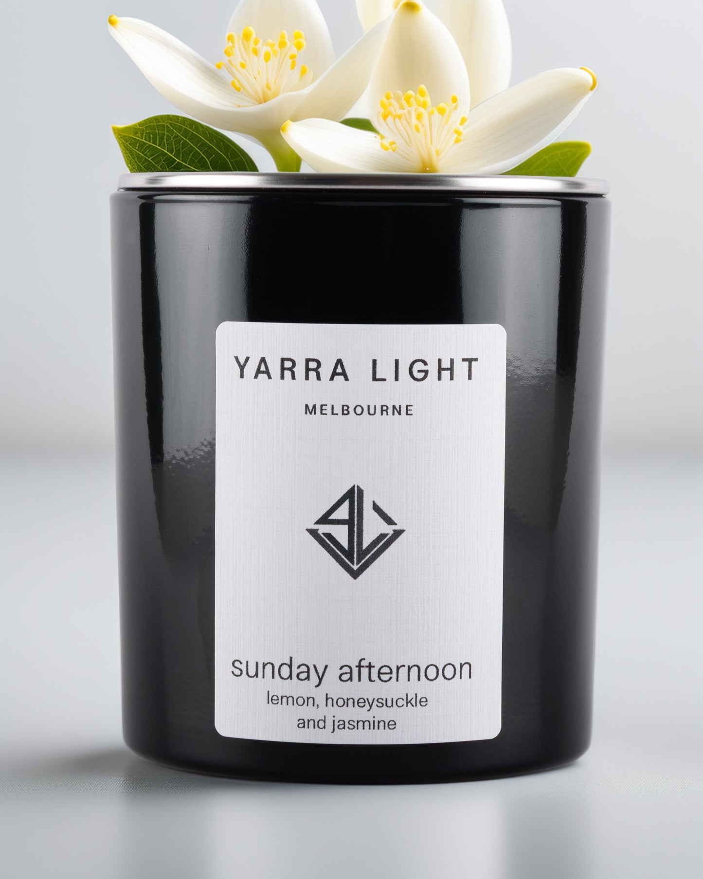 Yarra Light soy wax candle and white flowers on top