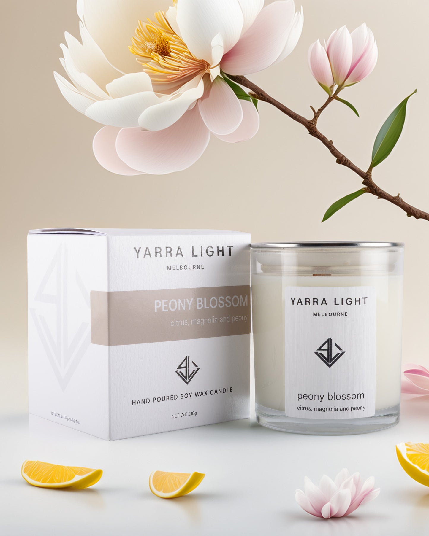 Yarra Light peony blossom candle and packaging with flowers and lemons on a light background