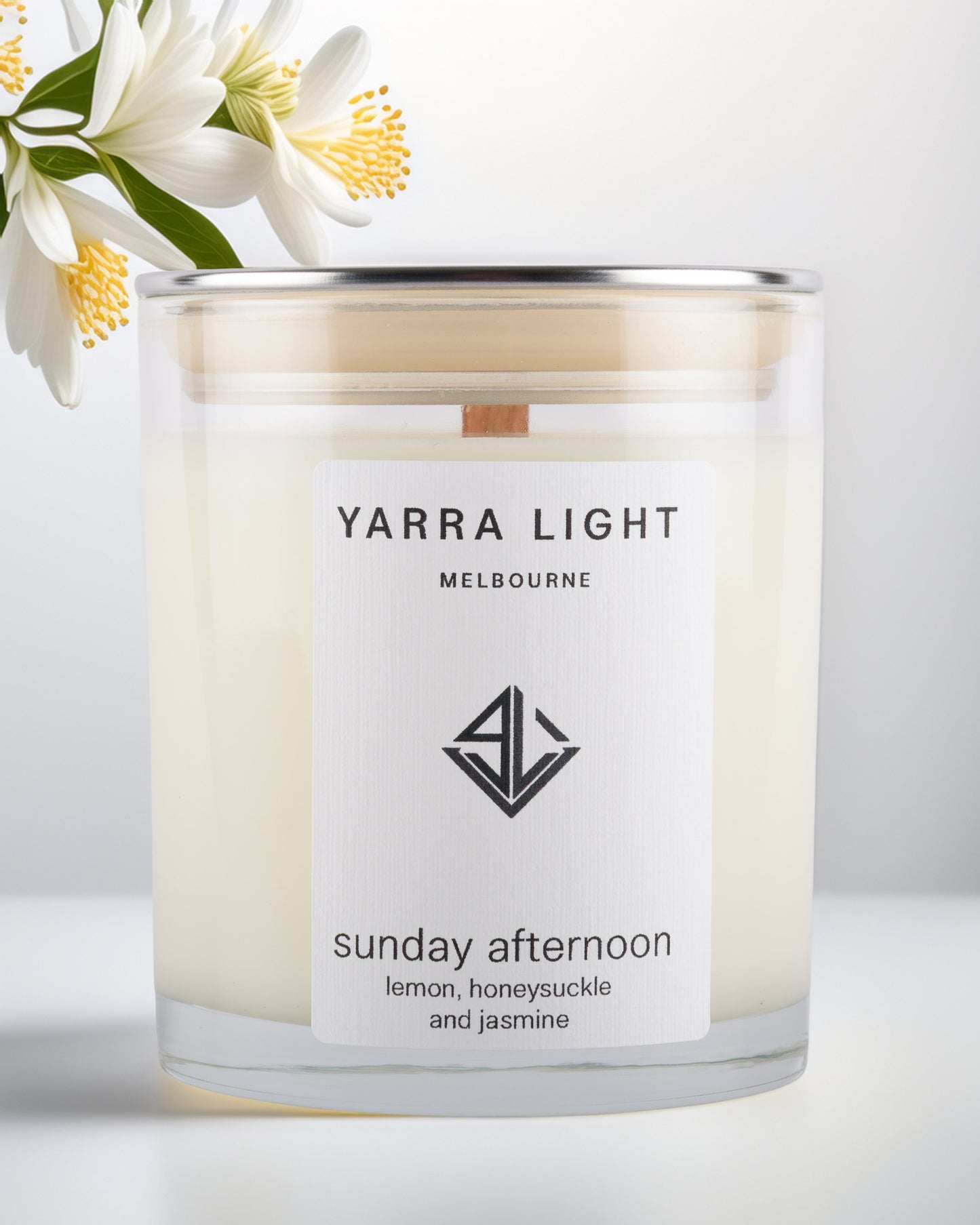Yarra Light soy wax candle with a floral arrangement on a light background
