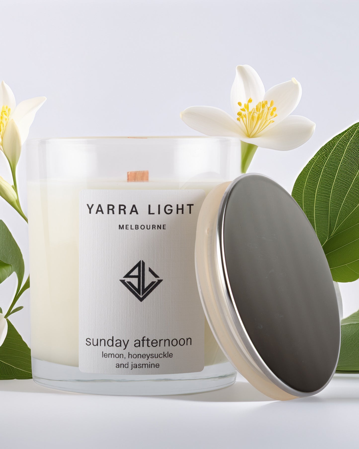 Yarra Light soy wax candle with floral elements on a light background