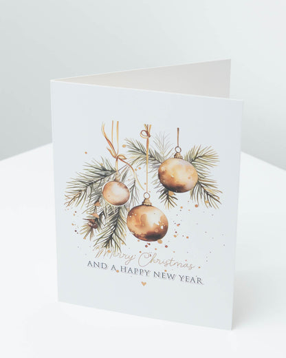 Christmas card with gold baubles among pine needles, reading Merry Christmas and a Happy New Year