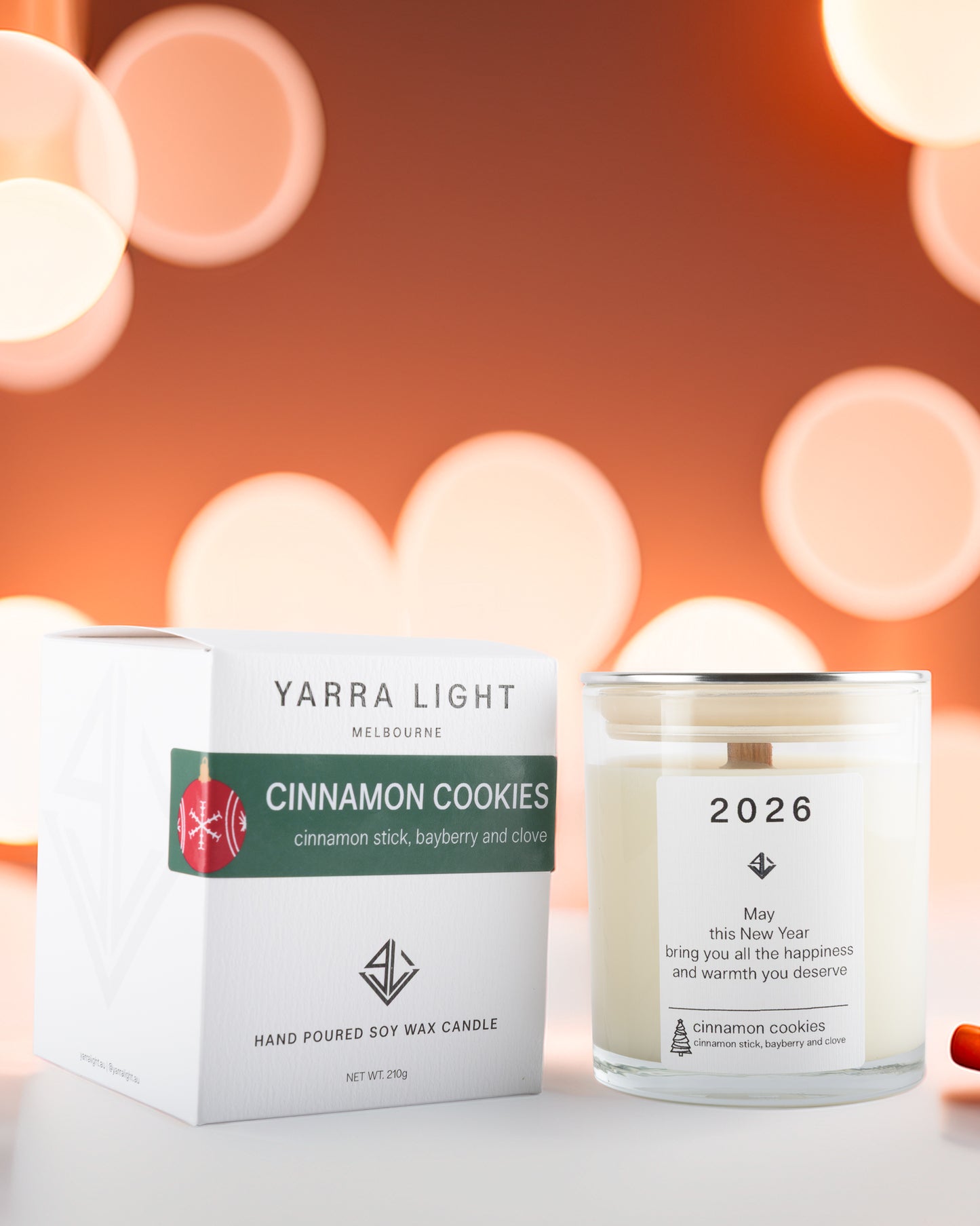 Yarra Light cinnamon cookies candle and packaging with a blurred bokeh background