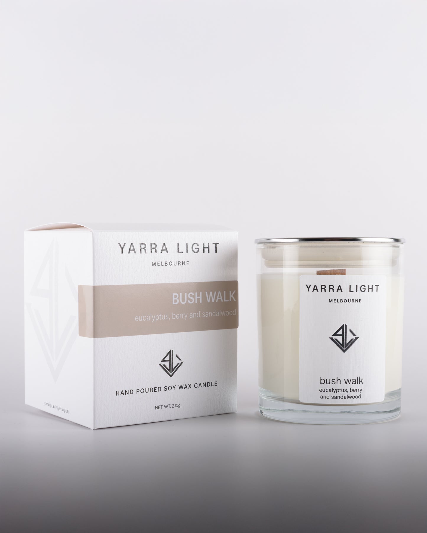Bush Walk soy wax scented candle in a clear glass jar with minimalist label, positioned next to its eco-friendly packaging box, inspired by Australian bushland.