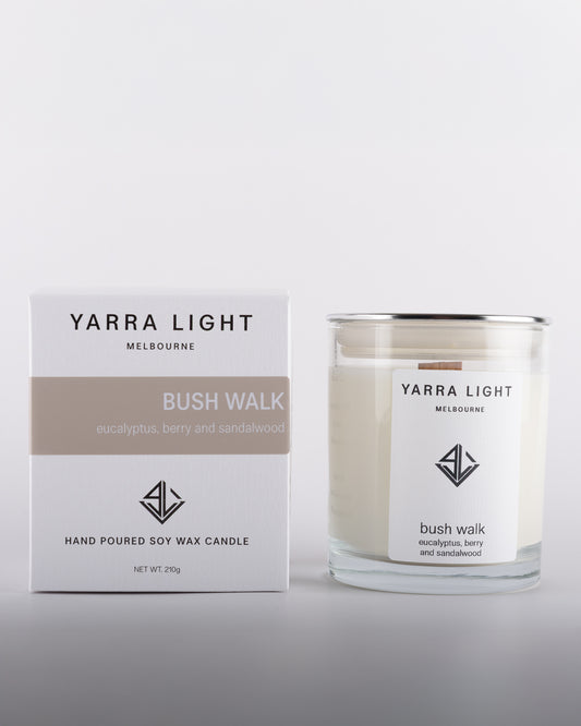 Bush Walk soy wax scented candle in a clear glass jar with minimalist label, positioned next to its eco-friendly packaging box, inspired by Australian bushland.