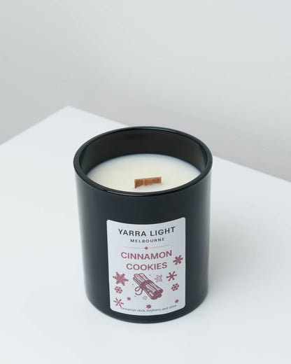 Cinnamon Cookies Christmas soy candle in black glass with a wood wick and a cinnamon stick label