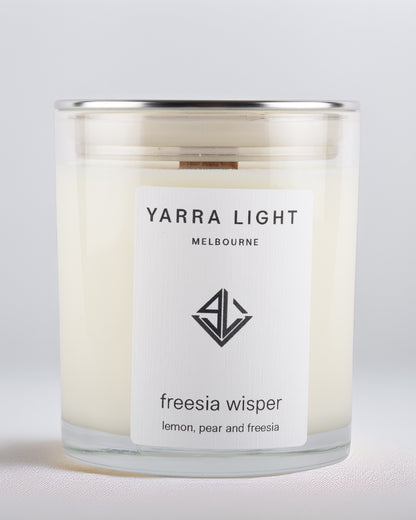 Yarra Light Melbourne soy wax  candle with freesia fragrance on a light gray background