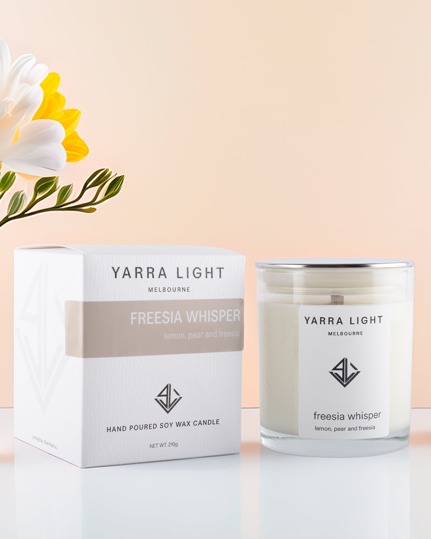 Yarra Light Freesia Whisper soy candle and packaging on a light background