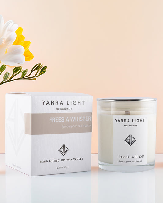 Yarra Light Freesia Whisper soy candle and packaging on a light background
