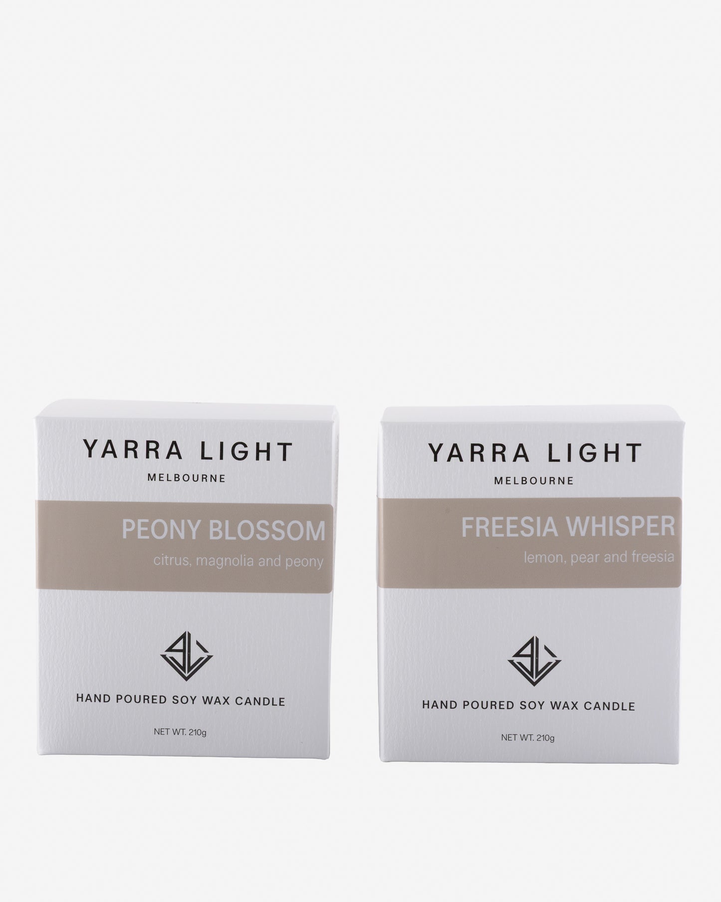 Two Yarra Light candles boxes, one labeled 'Peony Blossom' and the other 'Freesia Whisper', on a white background.
