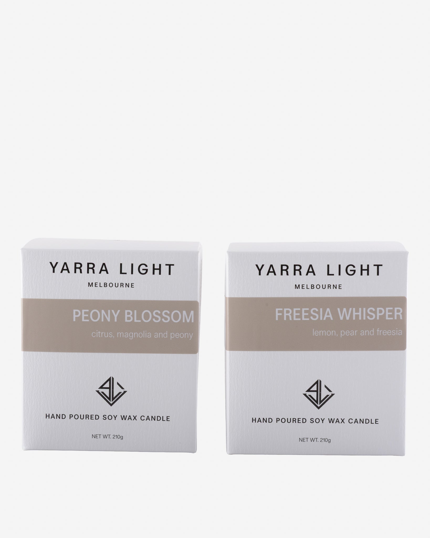 Two Yarra Light candles boxes, one labeled 'Peony Blossom' and the other 'Freesia Whisper', on a white background.
