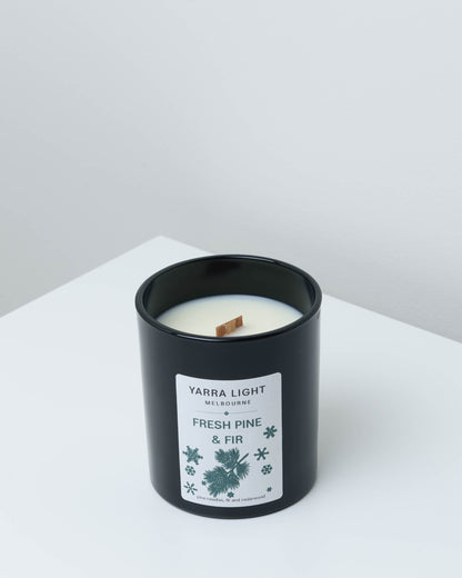 Fresh Pine & Fir Christmas soy candle in black glass with a wood wick and a pine sprig label