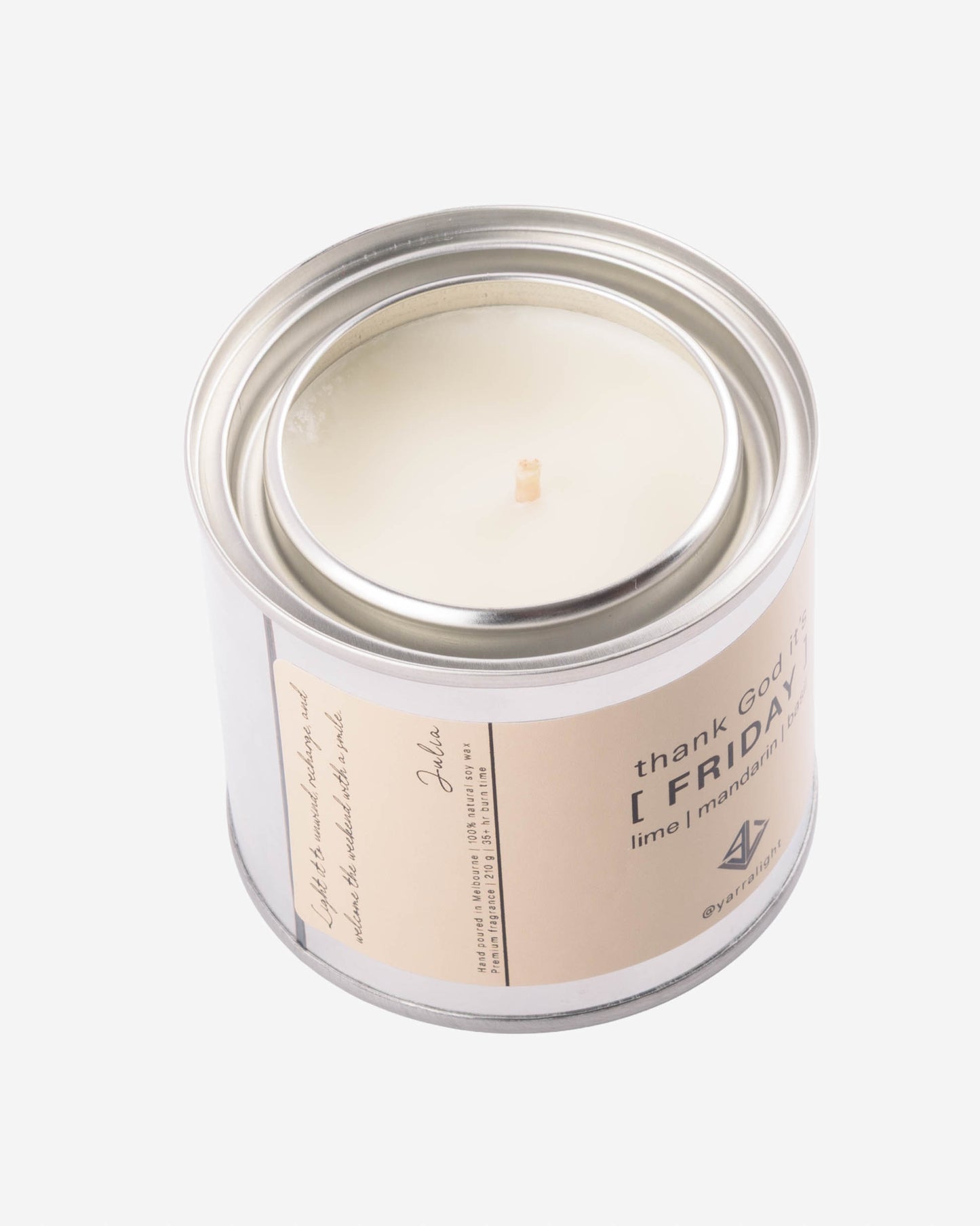 Soy wax scented candle in a tin jar with a label on a white background