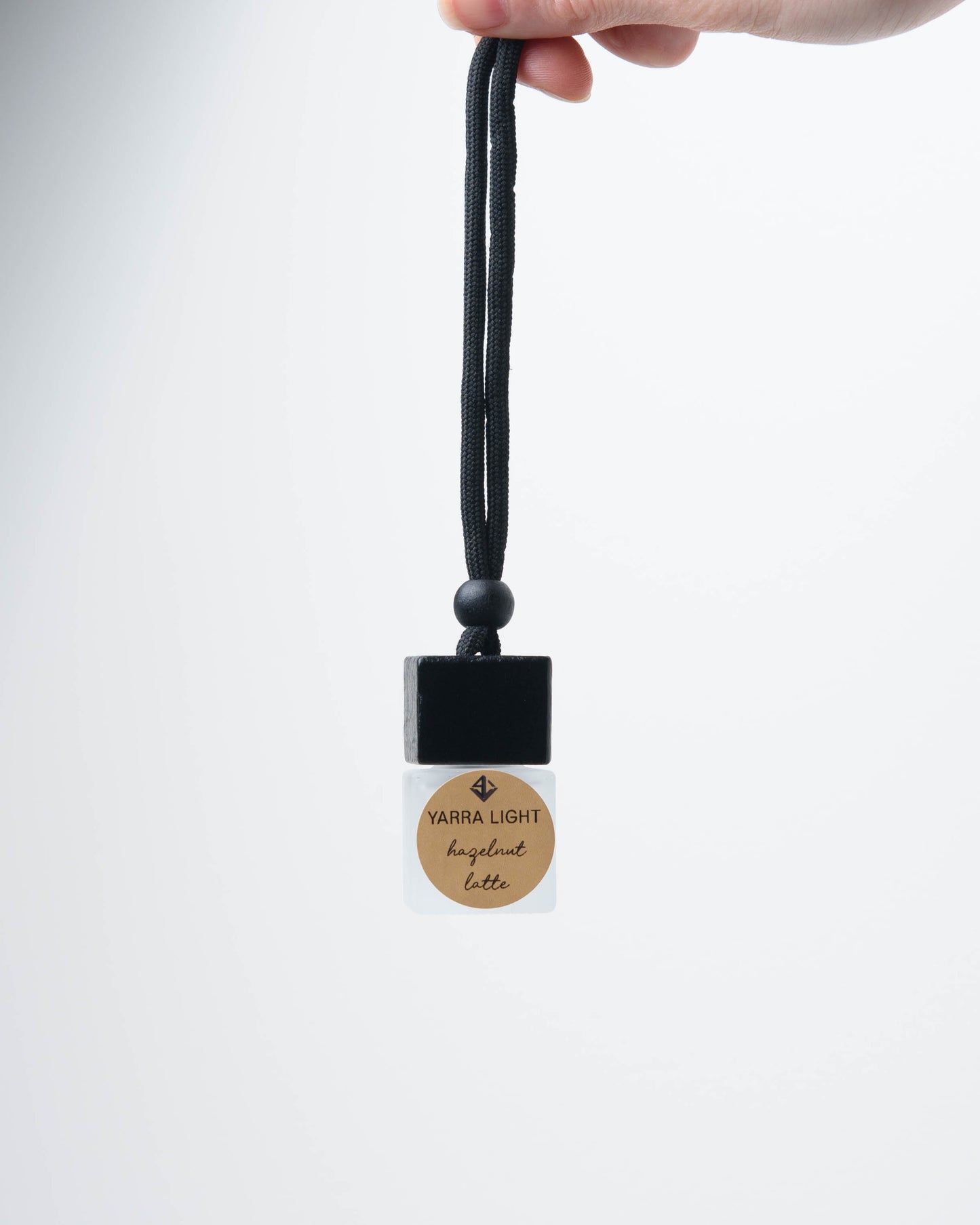 Hazelnut Latte hanging car diffuser, long-lasting car air freshener in a glass bottle with notes of roasted coffee, hazelnut, and creamy vanilla.