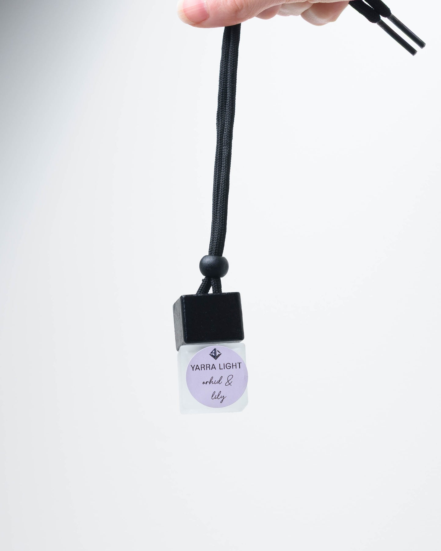 Orchid & Lily hanging car diffuser, long-lasting car air freshener in a glass bottle with notes of orchid, lily and jasmine.