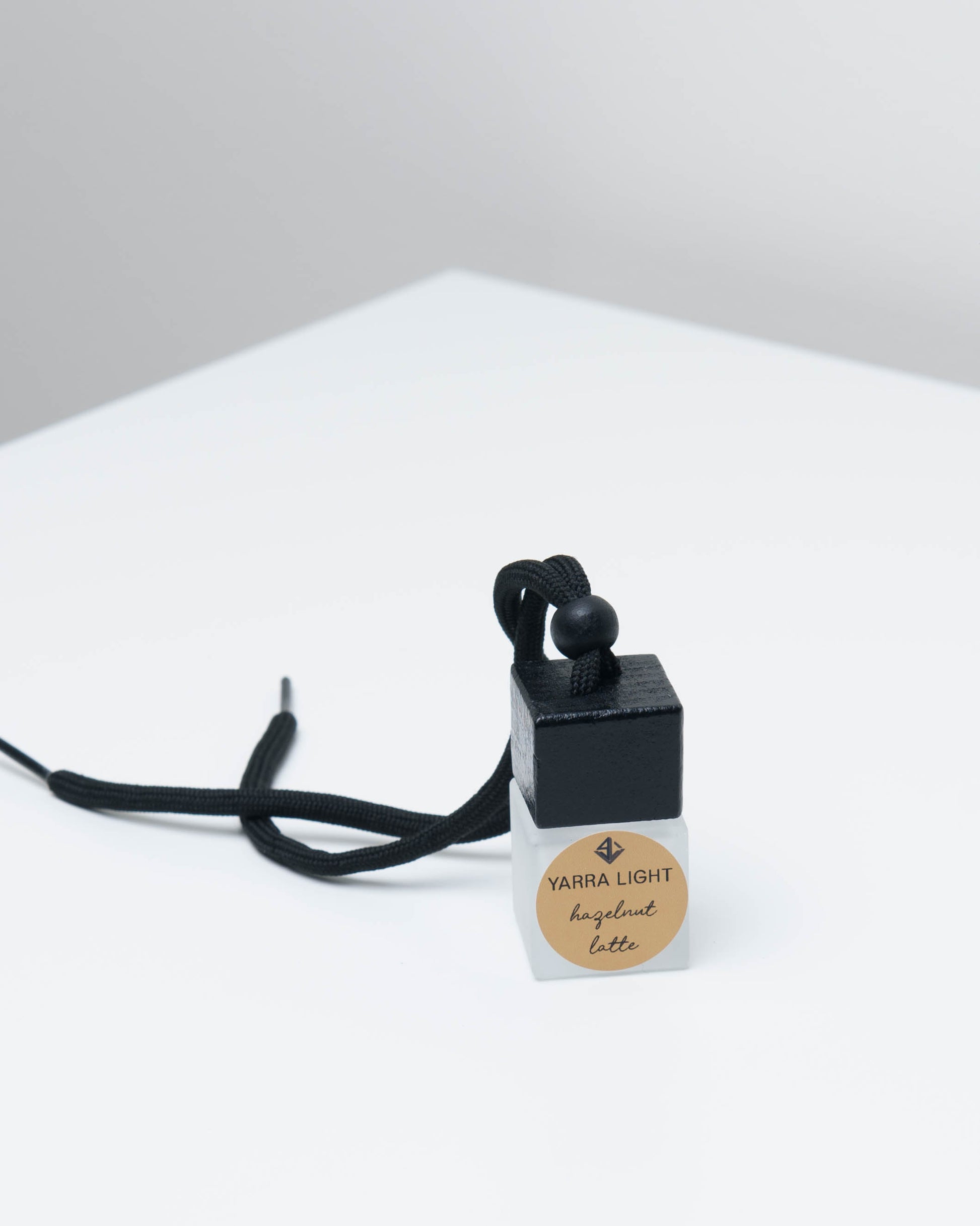 Hazelnut Latte hanging car diffuser, long-lasting car air freshener in a glass bottle with notes of roasted coffee, hazelnut, and creamy vanilla.