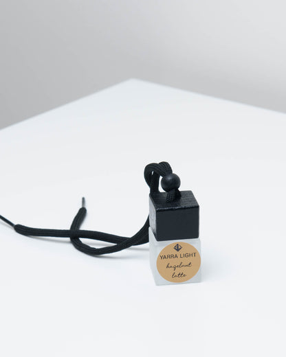 Hazelnut Latte hanging car diffuser, long-lasting car air freshener in a glass bottle with notes of roasted coffee, hazelnut, and creamy vanilla.