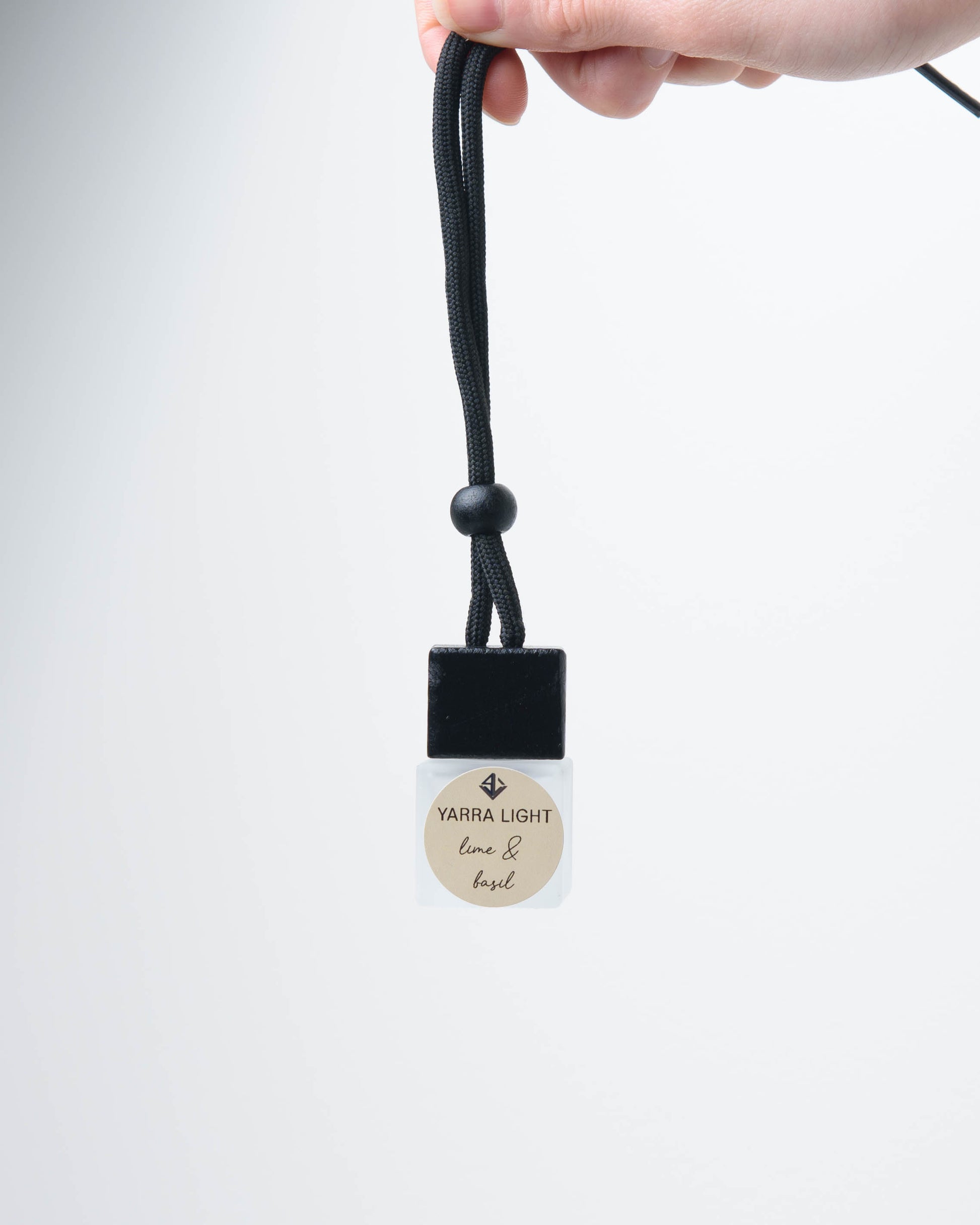 Lime & Basil hanging car diffuser, long-lasting car air freshener in a glass bottle with notes of lime, mandarin and basil.
