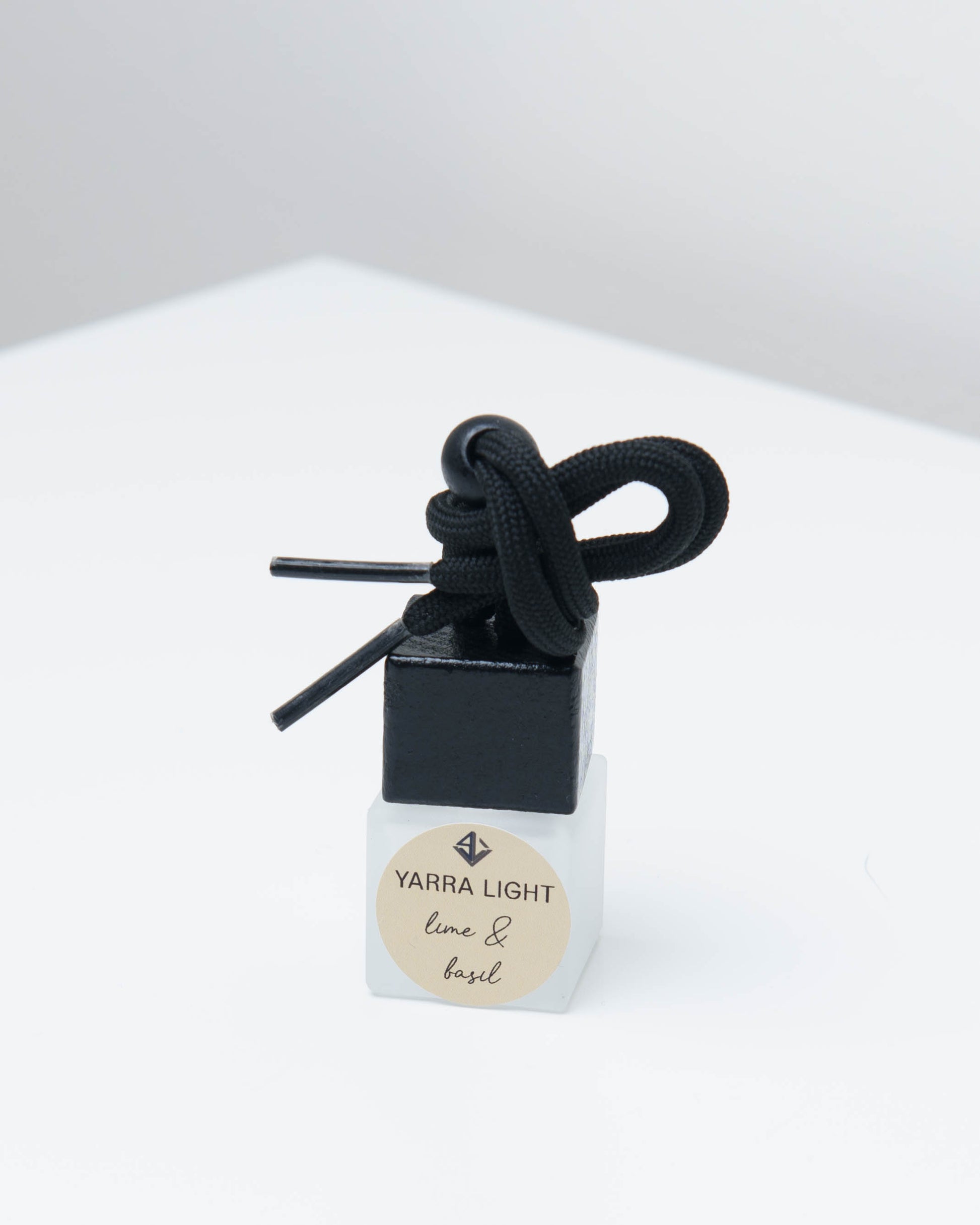 Lime & Basil hanging car diffuser, long-lasting car air freshener in a glass bottle with notes of lime, mandarin and basil.