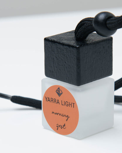 Morning Zest hanging car diffuser, long-lasting car air freshener in a glass bottle with notes of orange, grapefruit and jasmine.