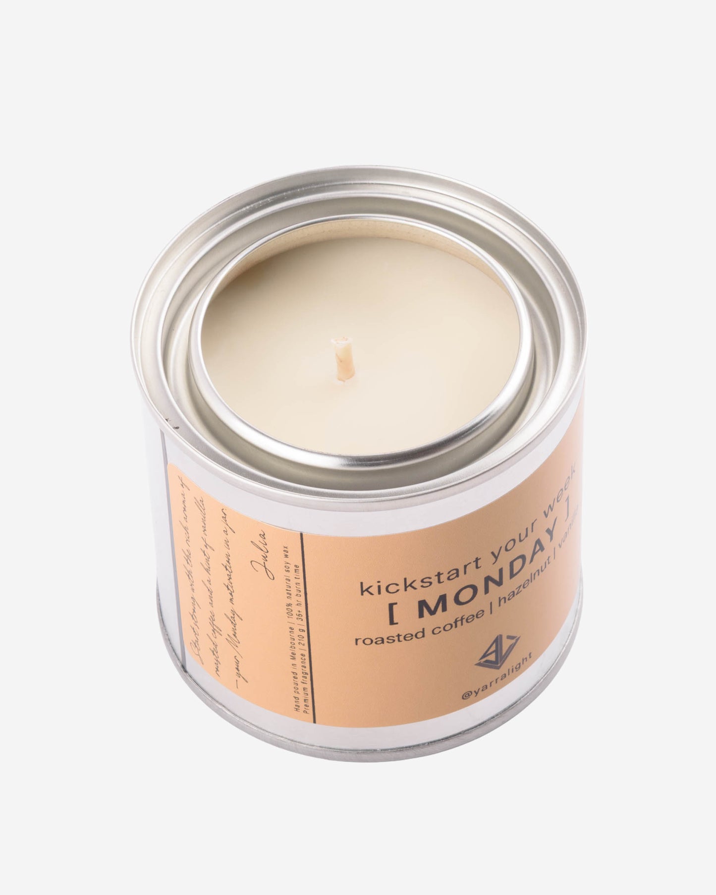 Candle in a metal jar with a label on a white background
