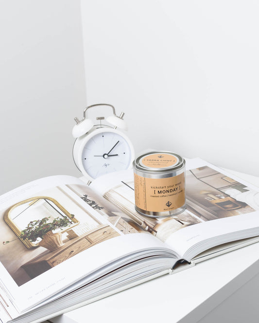 Soy wax candle on an open magazine with a light background