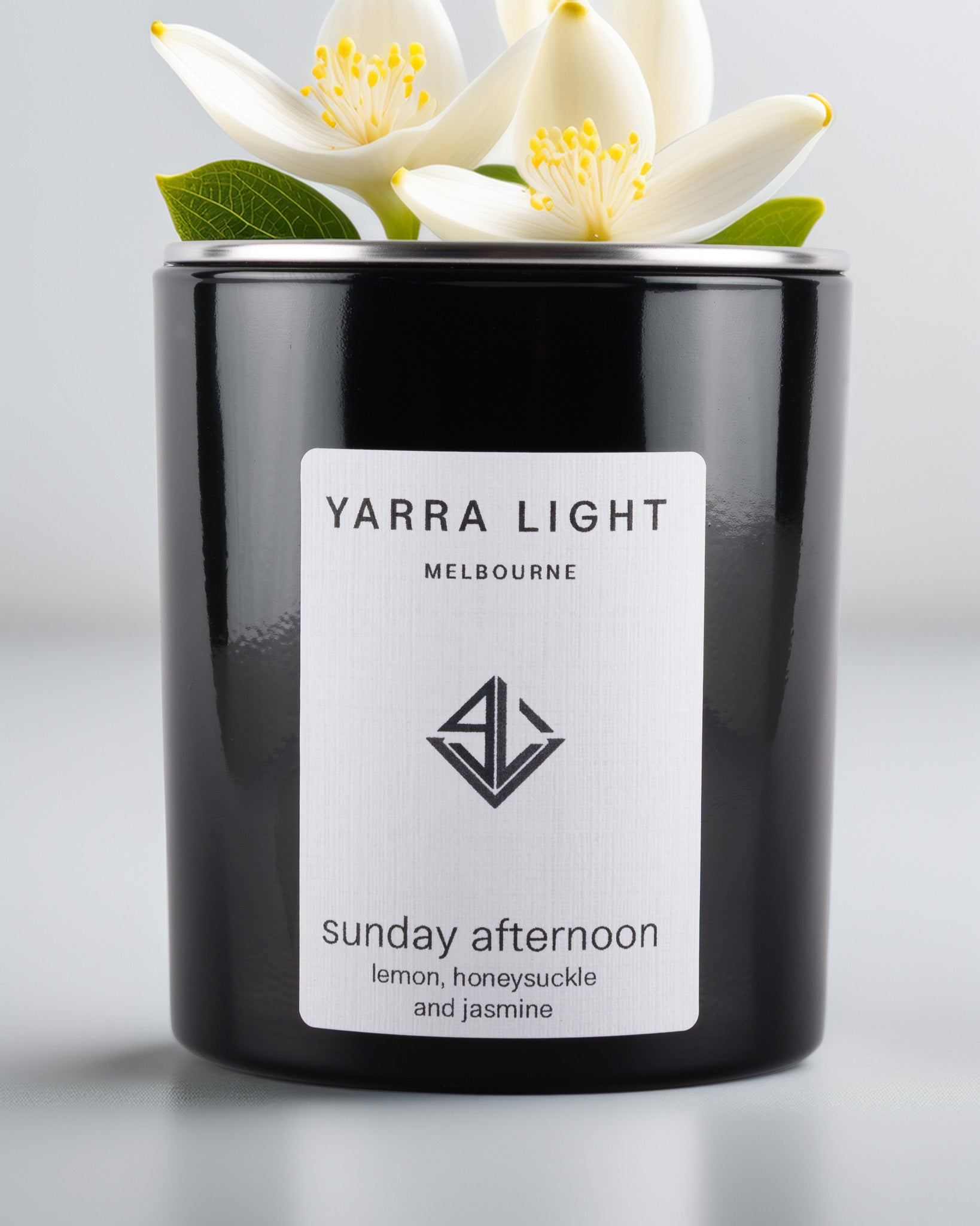 Yarra Light soy wax candle and white flowers on top