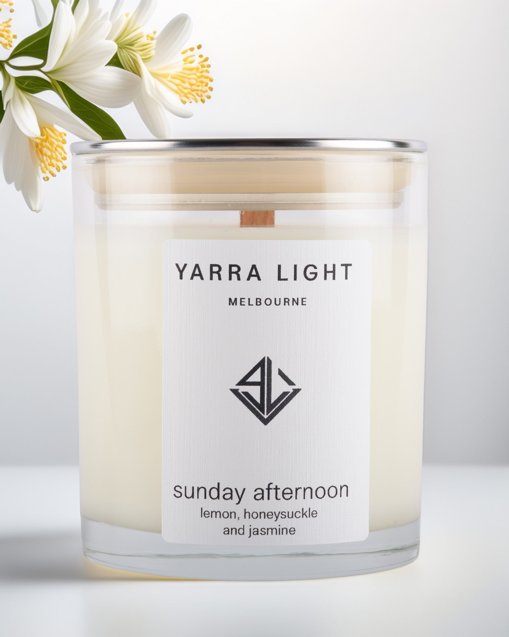 Yarra Light soy wax candle with a floral arrangement on a light background