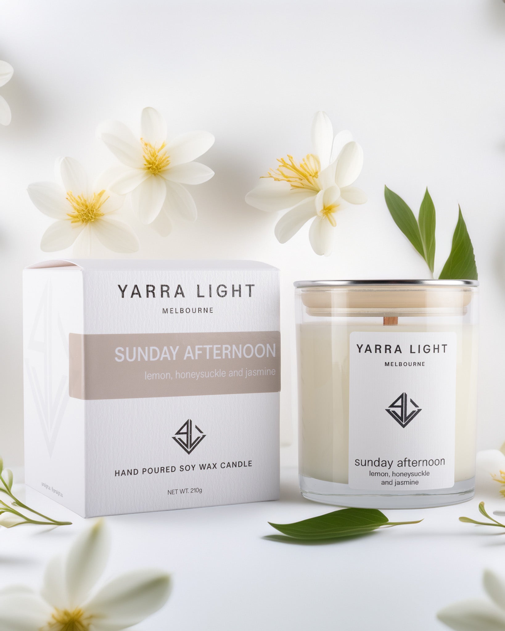 Yarra Light soy wax candle and packaging with flowers on a white background