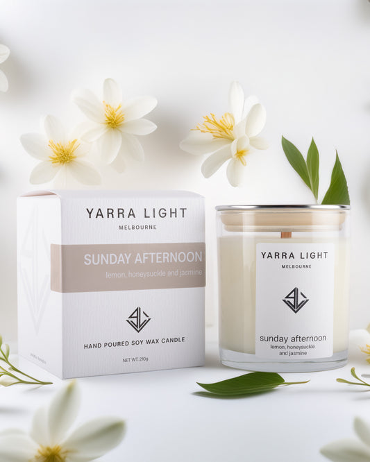 Yarra Light soy wax candle and packaging with flowers on a white background