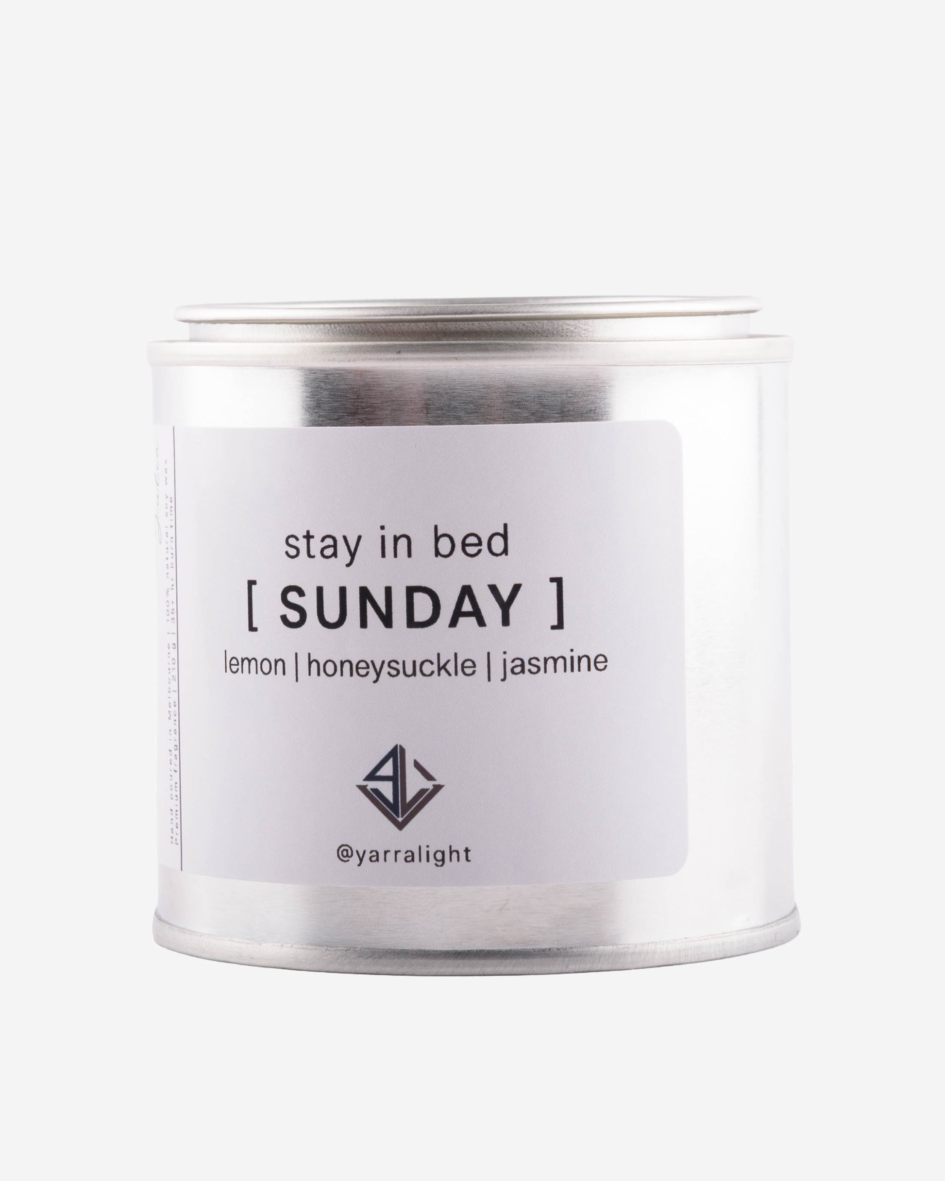 Candle jar labeled 'stay in bed [SUNDAY]' with scents lemon, honeysuckle, jasmine on a white background.