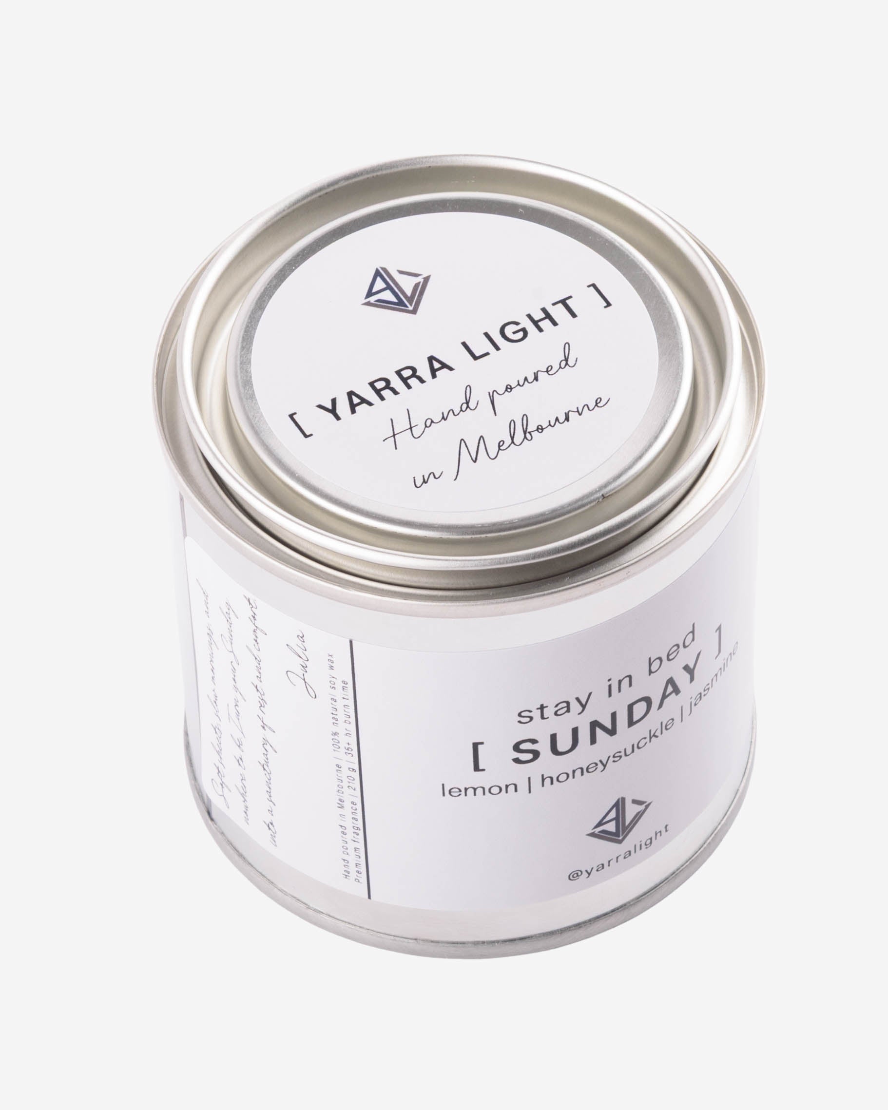 Yarra Light soy wax candle jar with white label on a light gray background